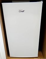 Front view of white Master Chef mini fridge closed
