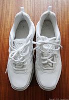 Top view of both white shoes showing laces and overall condition