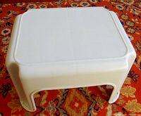 Top view of off-white Rubbermaid plastic step stool showing textured surface and rounded edges