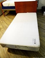 Top view of twin mattress on box spring and frame