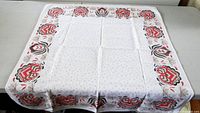Full view of tablecloth laid flat showing dimensions and border pattern