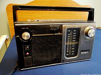 Front view showing speaker grille, tuning dial, controls and handle