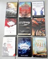 Front view of all nine sealed DVD and CD cases arranged in three-by-three grid