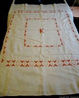 Full view of wool lap blanket showing pattern and monogram