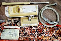 Full view of vacuum canister, hose, wand and attachments