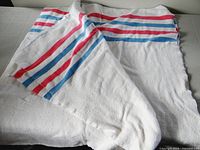 White flannel blanket folded on table showing stripe pattern