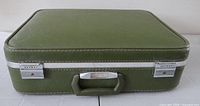 Front view of olive green Skyway suitcase showing handle and latches