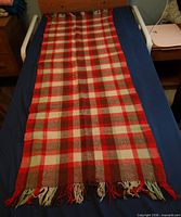 Full view of wool plaid shawl laid flat showing size and pattern
