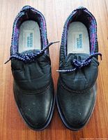 Top view of both shoes showing brand logo and laces