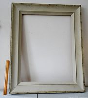 Full view of pale grey wood frame standing upright