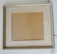 Full view of rectangular wood frame with mat and glass
