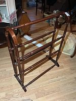 Full view of wood blanket rack, three rails, turned legs