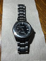 Front view of Bulova Precisionist watch showing black dial, hands, date window and bracelet