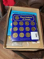 Box containing Shell display cards and booklet with medallions