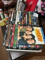 Full tray of DVDs with Seinfeld box set on top
