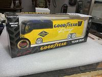 Front of boxed Goodyear Racing diecast team bus showing bus through window and product branding