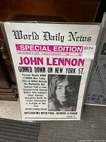 Full view of poster showing headline, image of John Lennon, overall design