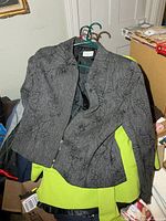 Grey embroidered blazer over lime blazer on hangers