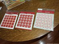 Three sealed stamp panes laid out on table