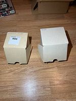 two small corrugated cardboard boxes holding contents
