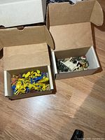 two open boxes showing contents of vintage Marx plastic figures