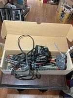 Open box showing transformer, bundled track and wheel assemblies