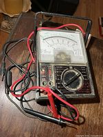 Front view of Micronta analog multimeter with probes attached