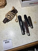 All five pocket knives on countertop