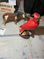 Horse and cardinal figurines side by side
