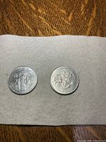 Two coins side by side showing obverse and reverse designs
