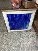 Front view of stained glass panel showing full blue swirled glass and frame
