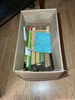 Cardboard box containing assorted vintage books