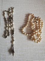 Both necklaces laid flat showing overall design