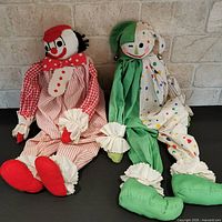 Both cloth clown dolls side by side