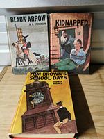 Front covers of the three hardcover novels showing titles and artwork