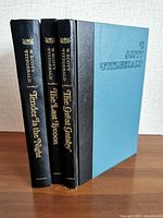 Three standing hardcovers showing uniform design and titles on spines