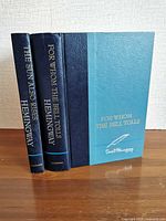 Spine and front cover view of both Hemingway books standing upright