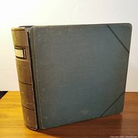 Front view of closed green cloth binder with diagonal corner lines