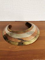 Front view showing tri-tone layered design and overall form