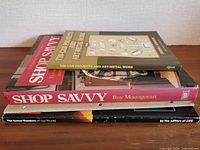 Stack view showing Tin Can Projects booklet, Shop Savvy book, LIFE Seven Wonders book