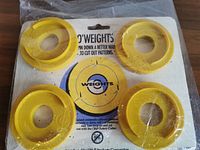 Front view of sealed package containing four yellow ring weights