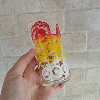 Front view of glass showing red and yellow pansy design