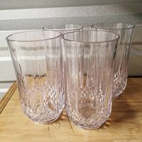 Set of four clear plastic tumblers front view