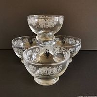 Stacked view showing all four bowls and etched rose pattern