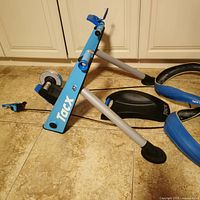 Overall view of Tacx Blue Motion trainer frame, front wheel block, tires and skewer