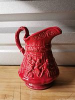 Front view showing relief tavern figures and spout