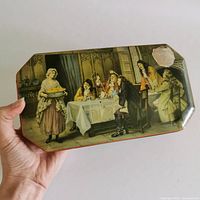 Top view of tin showing tavern scene lithograph and wear