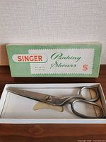 Singer pinking shears resting in open original box