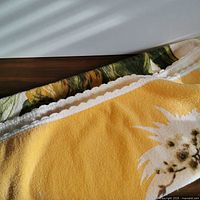 Corner of yellow terrycloth towel showing white edge