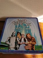 Tin lid with Wizard of Oz artwork and title